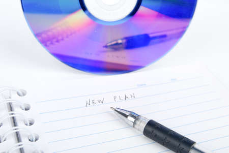 DVD and notepad with penの写真素材