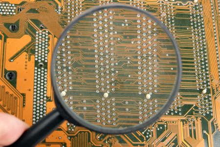 Printed circuit board and magnifying glassesの写真素材