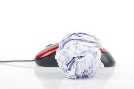 Crumpled paper ball and computer mouseの写真素材