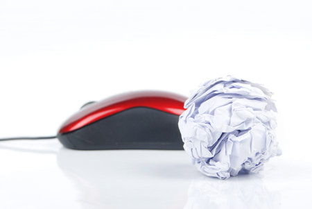 Crumpled paper ball and computer mouse