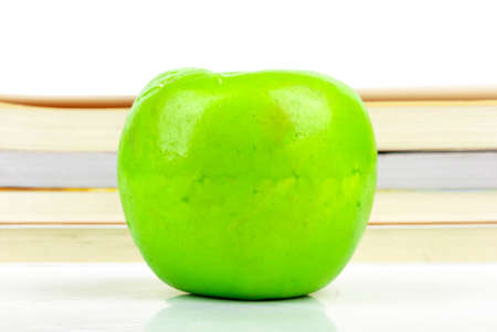 Green apple with booksの写真素材