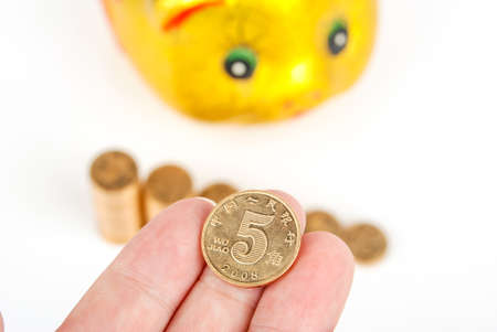 Golden piggy bank with coinsの写真素材