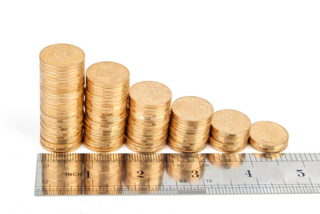 Coins with stainless steel rulerの写真素材