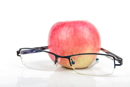Red apple and eyeglassesの写真素材