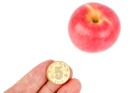 Apple with coins on white backgroundの写真素材