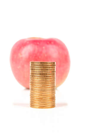 Apple with coins on white backgroundの写真素材