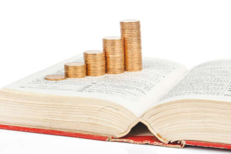 Coins with book on white backgroundの写真素材