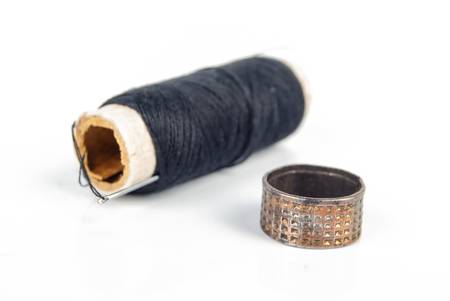 Thread,needle and thimble on white backgroundの写真素材