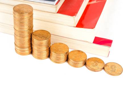 Books and coins on white backgroundの写真素材