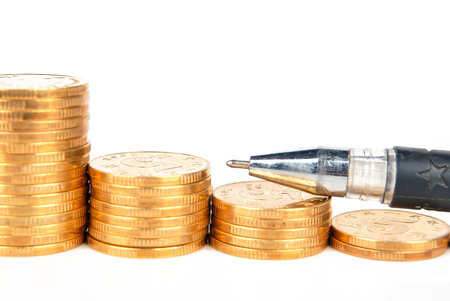Coins with pen on white background