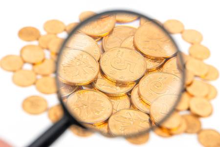 Magnifier and coin on white backgroundの写真素材