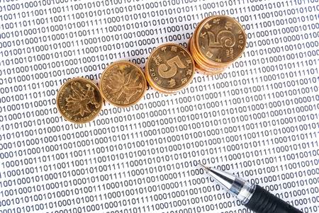 Coins with pen on binary codeの写真素材