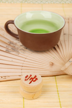 Tea,chinese fan with chess on bamboo tray