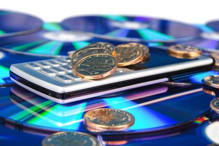 Mobilephone on DVD with coinの写真素材