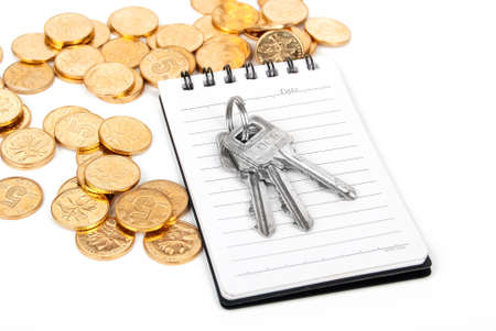 Key and notepad with coinの写真素材