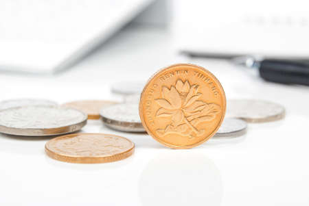 Coin and calculator with penの写真素材