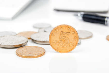 Coin and calculator with penの写真素材