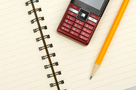 Pencil and notepad with mobile phoneの写真素材