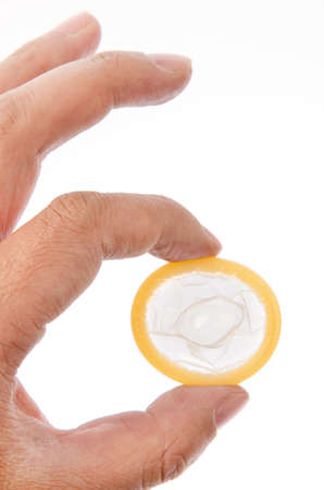 Hand with condom isolated on whiteの写真素材