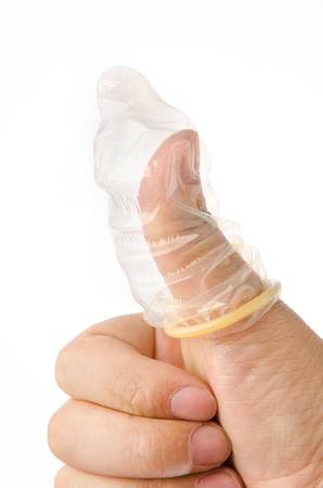 Hand with condom isolated on whiteの写真素材