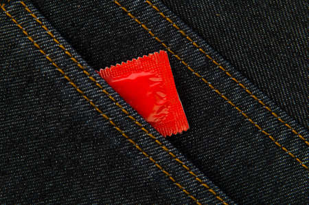 Condom in the pocket of a jeansの写真素材