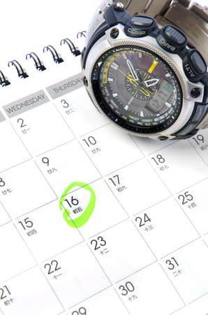 Wrist watch on the calendar backgroundの写真素材