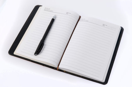 Notebook and pen on white background