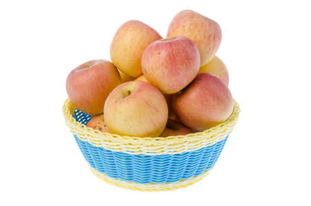 Basket full of apples isolated on whiteの写真素材