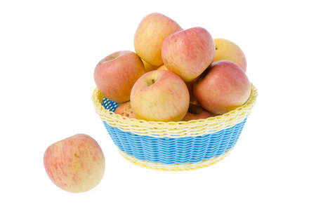 Basket full of apples isolated on whiteの写真素材