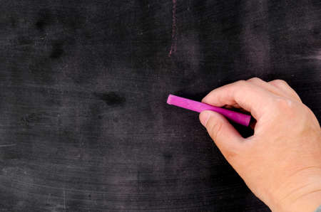 Row of color chalk on a blackboardの写真素材