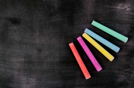 Row of color chalk on a blackboardの写真素材