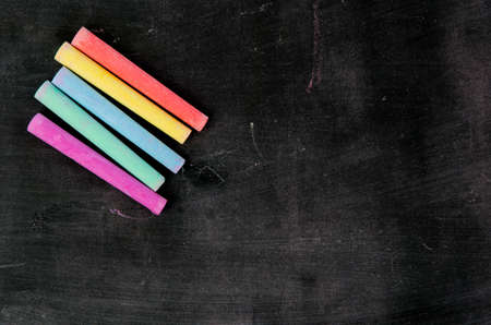 Row of color chalk on a blackboardの写真素材