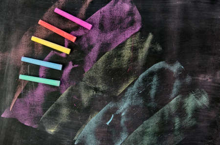 Row of color chalk on a blackboardの写真素材