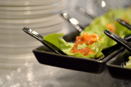 Thai mackerel lettuce wrap in white spoon on white plate eat with spicy sauce