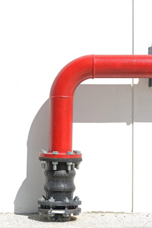 red pipeline extinguishing water in industrial building