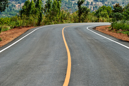 Road leading into the distance under blue skyの写真素材