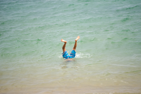 Funny underwater photo of happy foot with fun in seaの写真素材