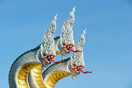 serpent three head on blue sky at WAT MUANG thailandの写真素材