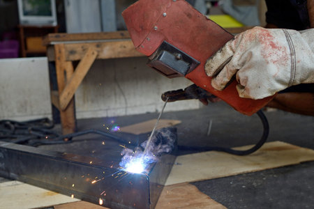 close-up man  Steel welding in him shop
