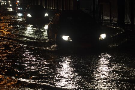 Flooded roads in Bangkok at night aftre rainingの写真素材