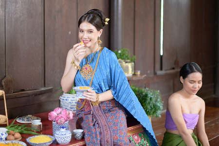 Thai people make Thai dessert in Thai period costumeの写真素材