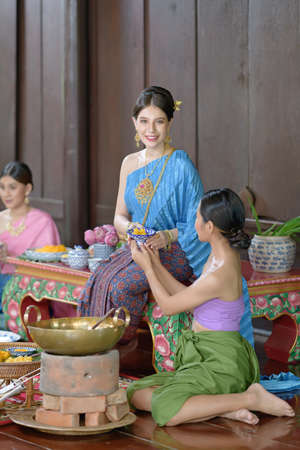 Thai people make Thai dessert in Thai period costumeの写真素材