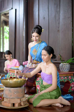 Thai people make Thai dessert in Thai period costumeの写真素材