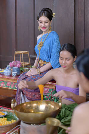 Thai people make Thai dessert in Thai period costumeの写真素材