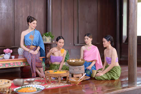 Thai people make Thai dessert in Thai period costumeの写真素材