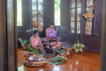 Thai woman cooking in retro Thai dressの写真素材
