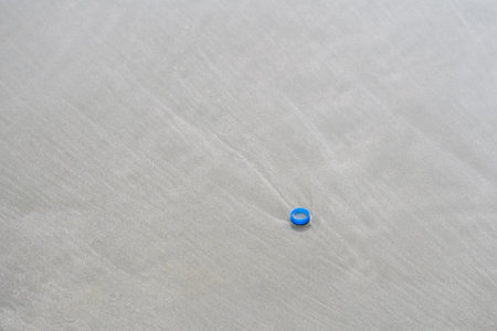 plastic water bottle cap on pattaya beachの写真素材