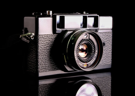 Retro film camera, close-up, back view, on black background.