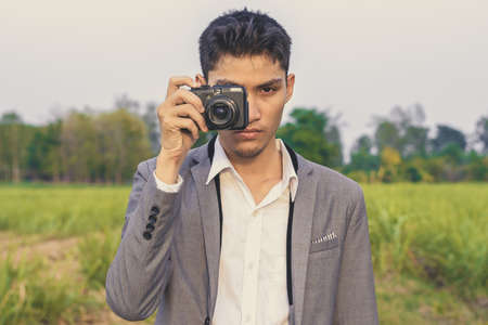 Photographer holding camera to a shot.の写真素材