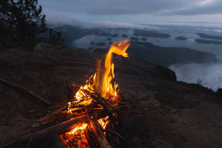 Campfire above coastal view on bay in the eveningの写真素材